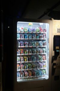Tall vending machine with drinks and snacks in Dallas