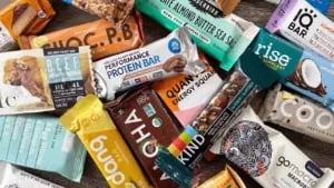 Variety of protein and energy bars, including popular brands like KIND, GoMacro, and Rise. 