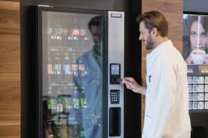 doctor tapping card to get a drink at the vending machine