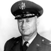 Black-and-white portrait of U.S. Fleet Admiral Chester W. Nimitz in naval uniform and braided cap.