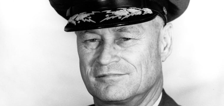 Black-and-white portrait of U.S. Fleet Admiral Chester W. Nimitz in naval uniform and braided cap.