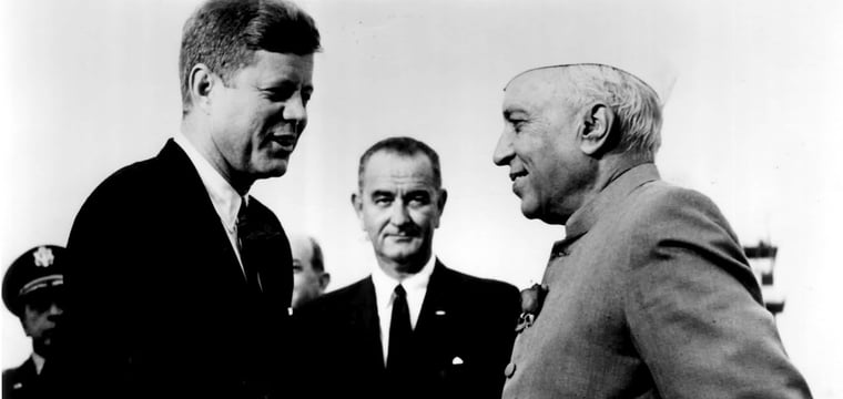 JFK shaking a gentleman's hand.
