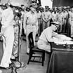 Fleet Admiral Chester Nimitz signs Japanese surrender documents aboard USS Missouri, Tokyo Bay, September 2, 1945.