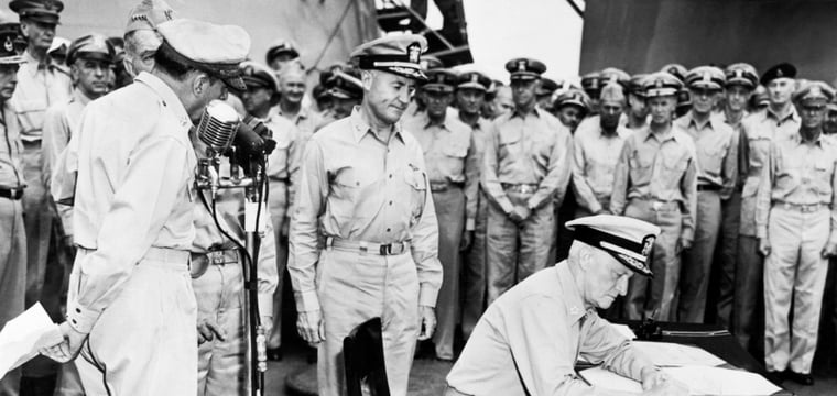 Fleet Admiral Chester Nimitz signs Japanese surrender documents aboard USS Missouri, Tokyo Bay, September 2, 1945.