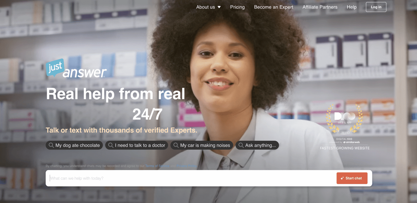JustAnswer homepage featuring a friendly expert in a lab coat standing in front of shelves stocked with products, promoting a 24/7 online help service.
