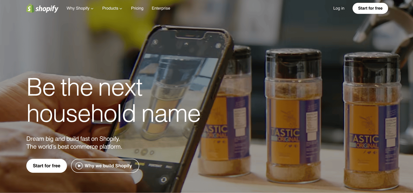 Shopify homepage with a seller photographing spice jars on a phone next to a Start for free button