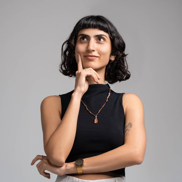 Eylül Güleryüz in a thinking pose with her finger on her chin