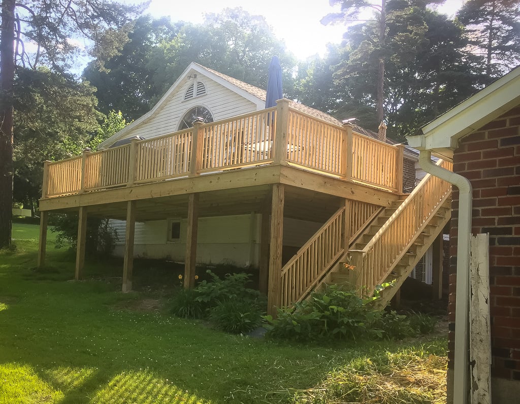 Raised deck with staircase on a brick home
