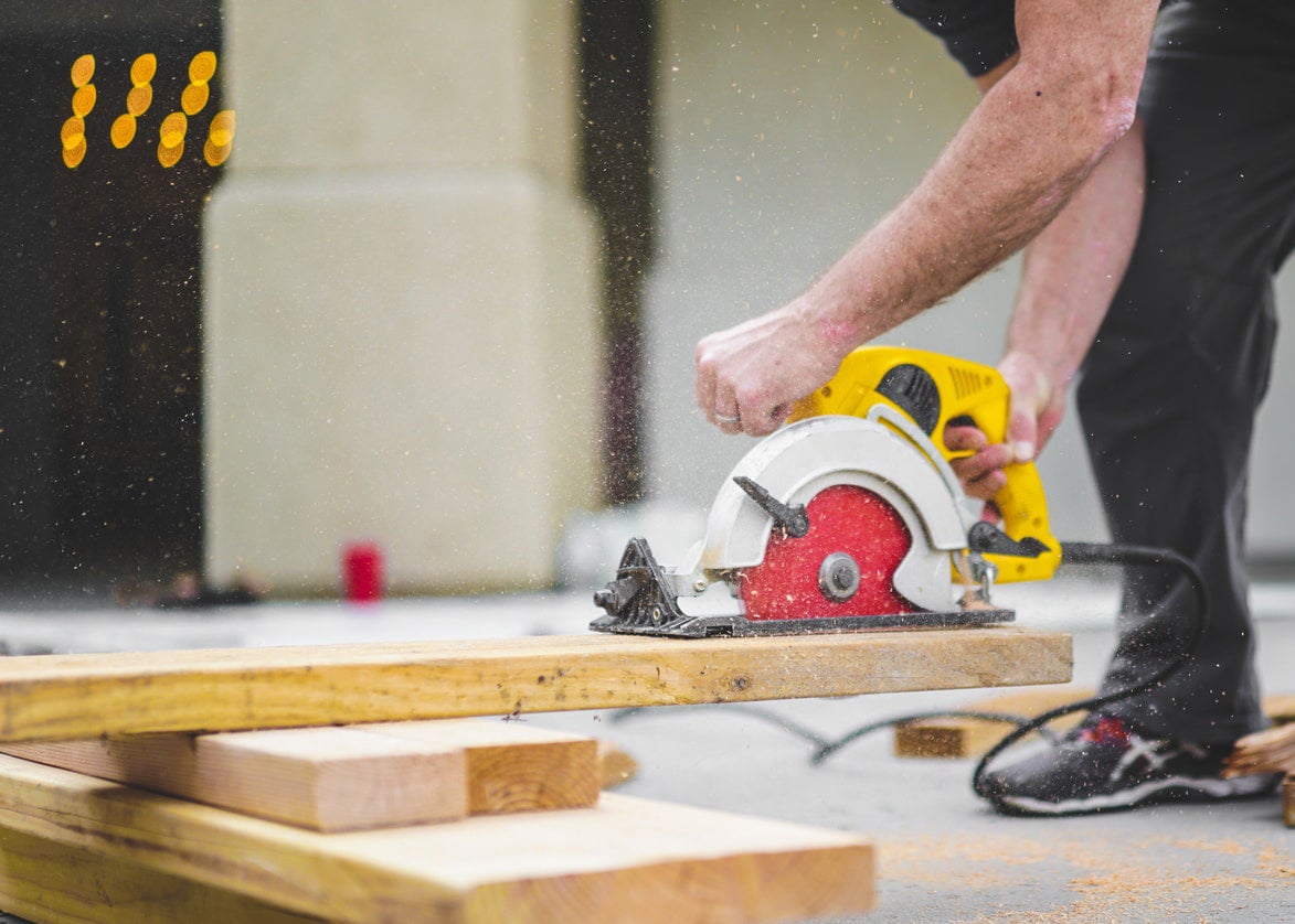 Contractor cutting lumber with a circular saw