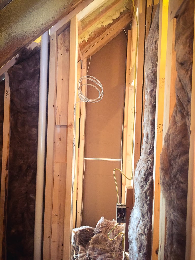 Insulation being installed between wall studs