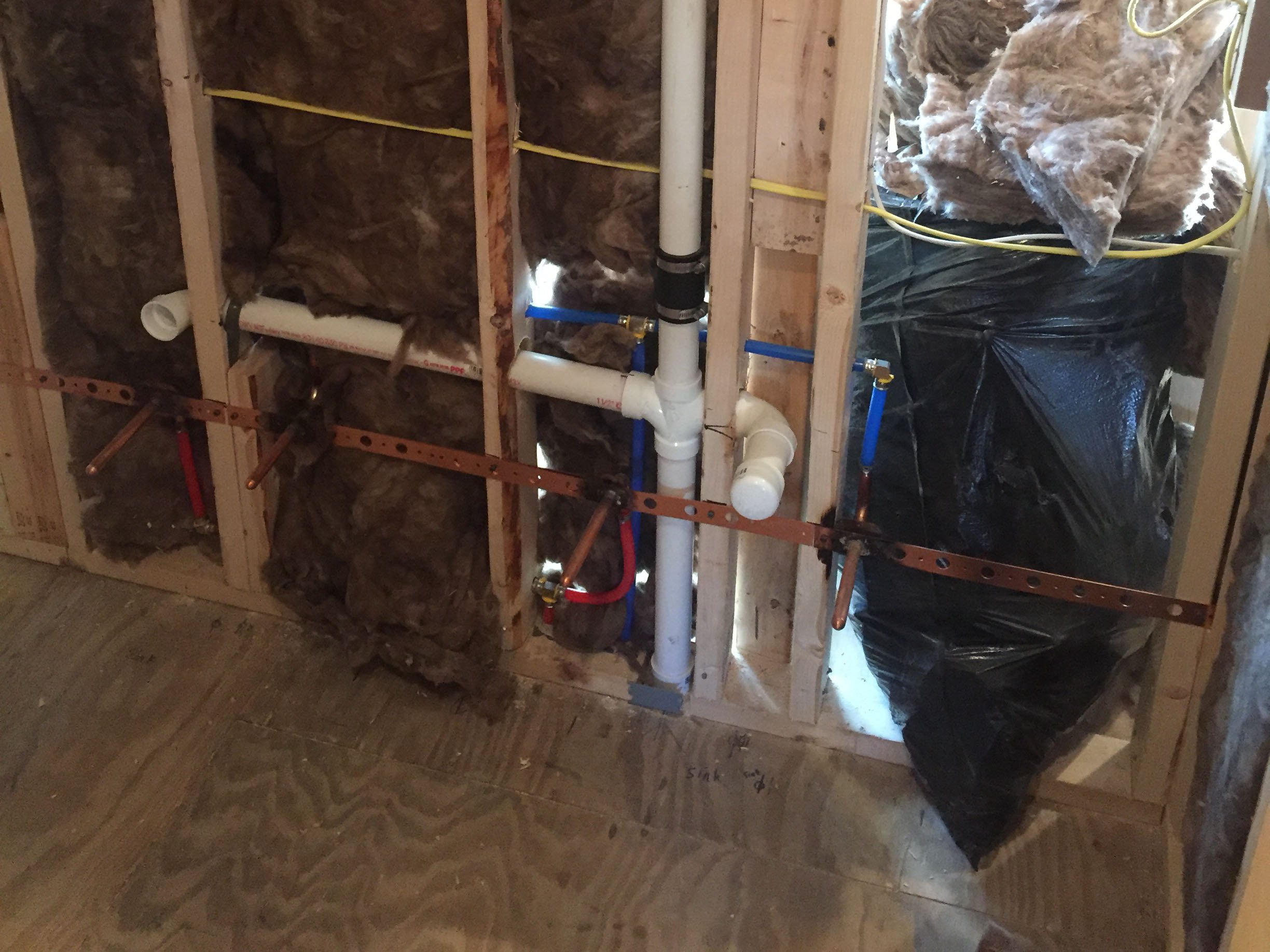 Interior wall with plumbing and insulation during construction