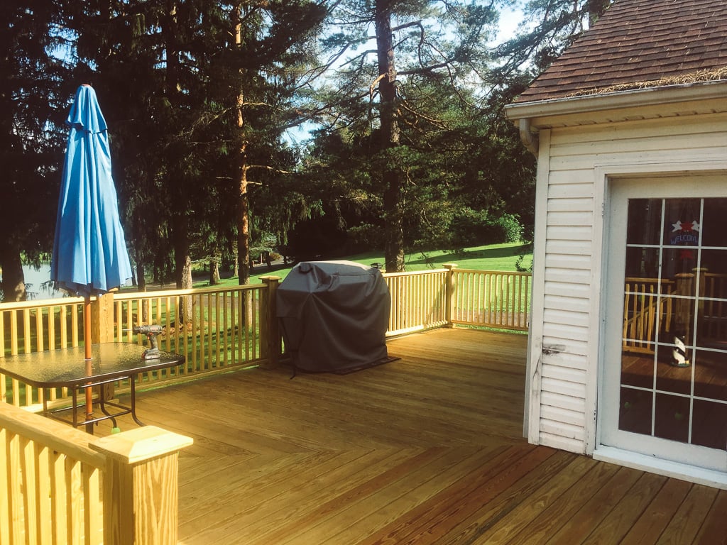 New wood deck with railing and patio furniture