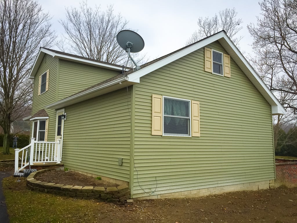 Green vinyl siding on a home with new windows
