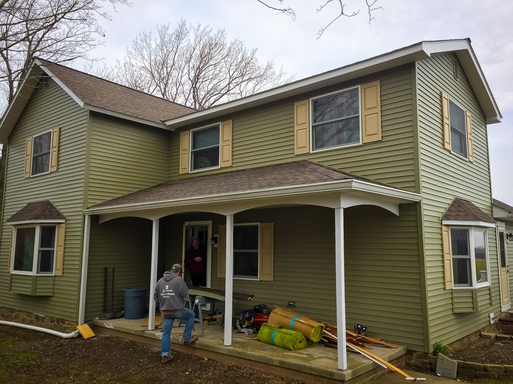 Completed green siding on a two-story home