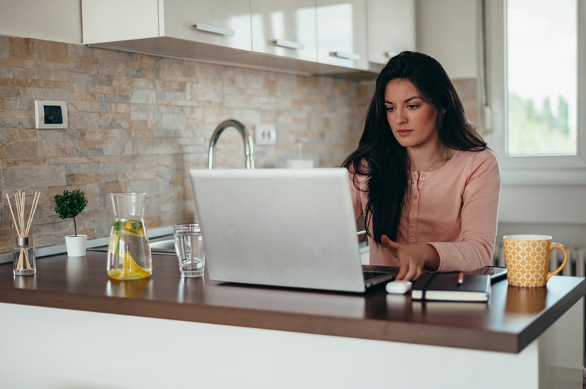 a woman working from her kitchen at home