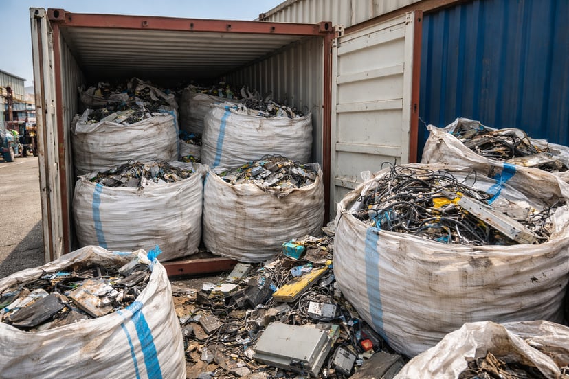 Sacks of e-waste in a shipping container in a port