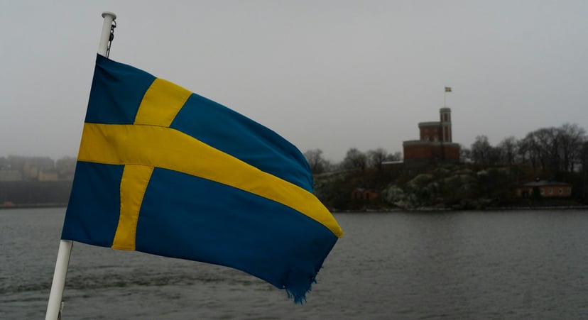 The flag of Sweden flying of the stern of a boat
