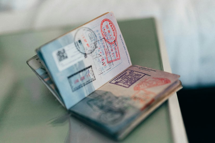An open passport with visa stamps in it