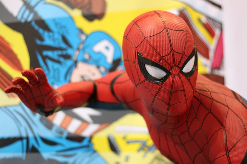 Spiderman in front of an image of Captain America