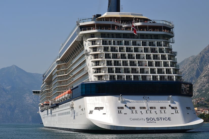 The Celebrity Solstice cruise ship sailing past mountains