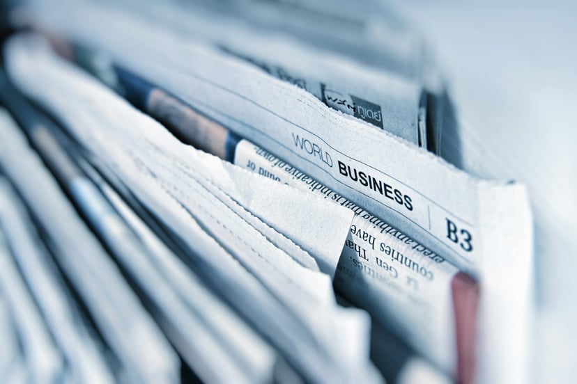 Newspapers with the World Business header prominently displayed