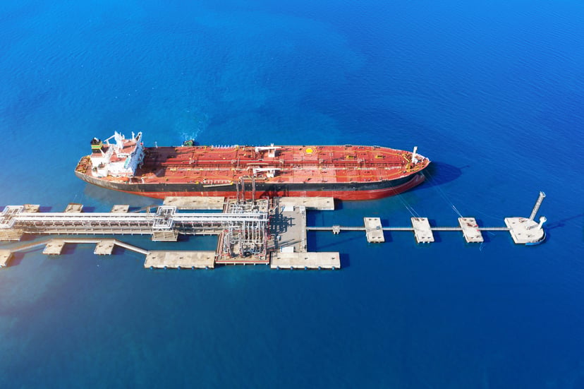an aerial view of a gas tanker at a dock