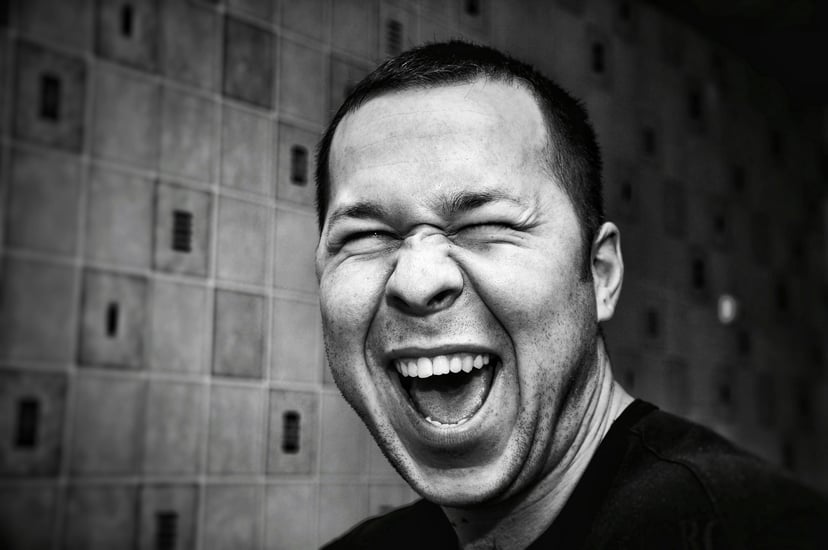 Man laughing with his eyes screwed up