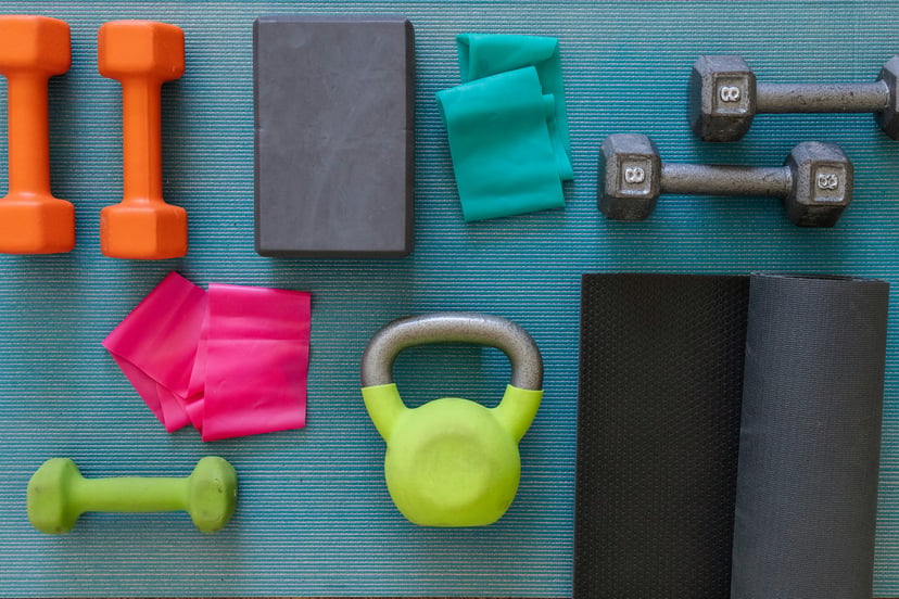 Fitness equipment including dumbbells and kettle bell on a matt