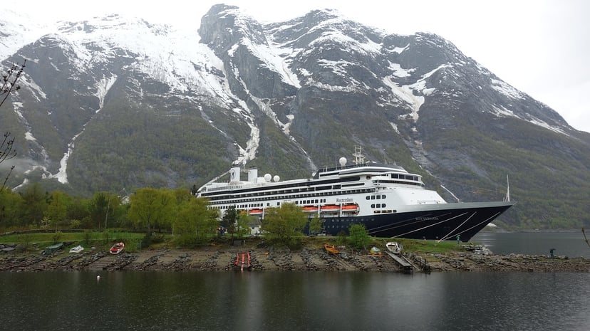 The Holland America Rotterdam cruise ship in front of snowy peaks