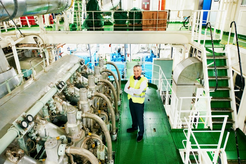 A marine engineer standing in a ship's engine room