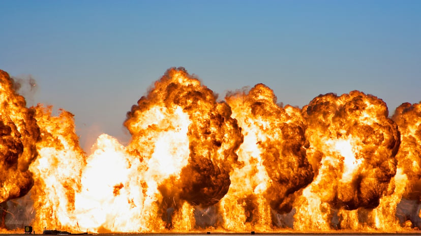 A fiery explosion against a blue sky