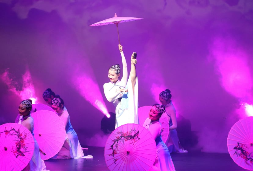 Chinese acrobats performing with parasols