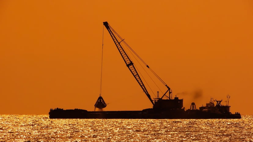 a dredger vessel at sunset