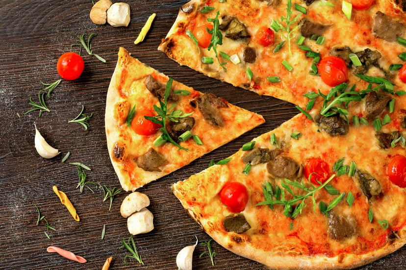 A pizza topped with cherry tomatoes and mushrooms