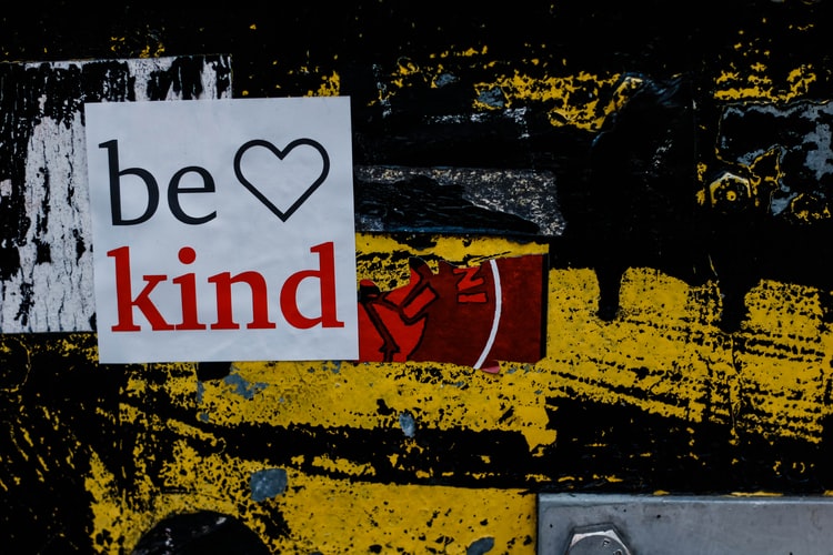 abstract art with a sticker on it saying 'be kind'