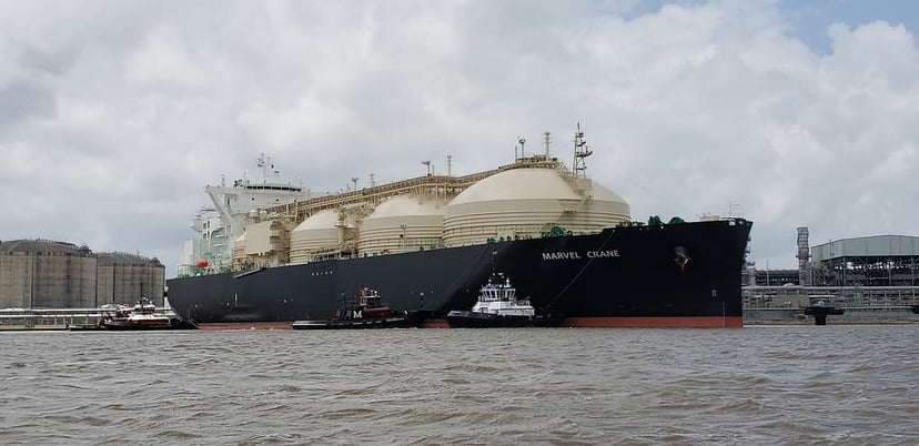 a blue gas carrier with four white gas tanks on its deck