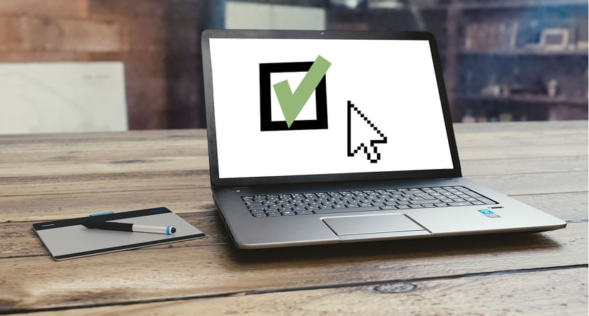 laptop with a checkmark on the screen
