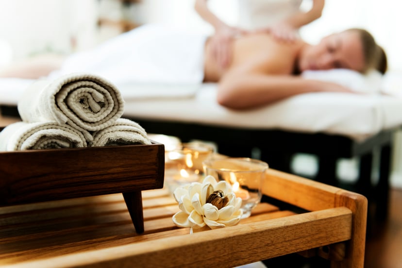 A woman receiving a massage in a luxury spa