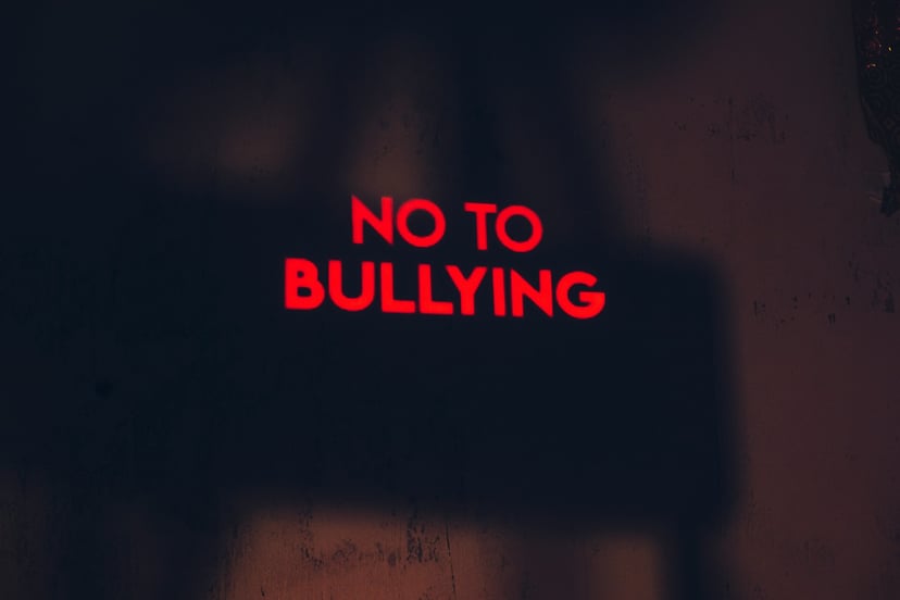 Red neon sign saying 'no to bullying'