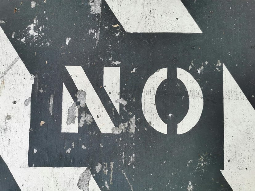 The word 'no' stenciled on he ground