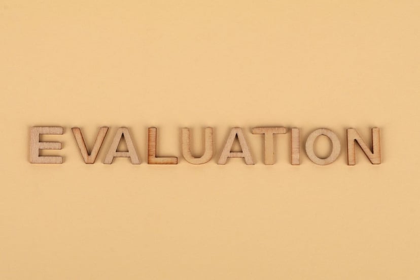 the word evaluation in wooden letters