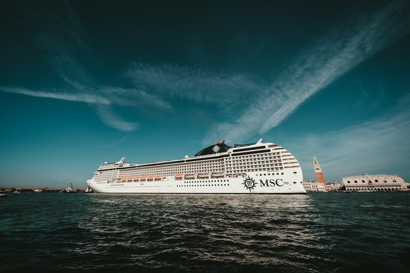 An MSC cruise ship under a dark blue sky