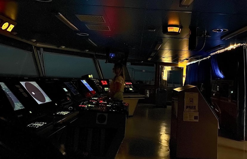 The bridge of a cargo ship at night 