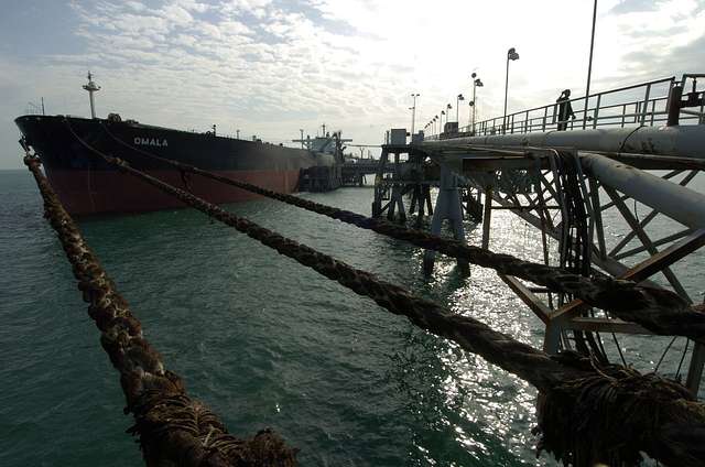 an oil tanker moored at a dock for the loading or unloading of cargo