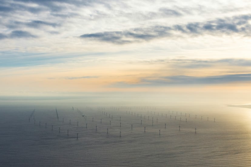 An offshore windfarm at sundown