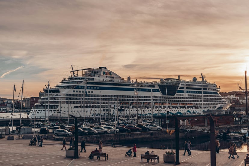 The AIDAdiva cruise ship docked in a port at sunset