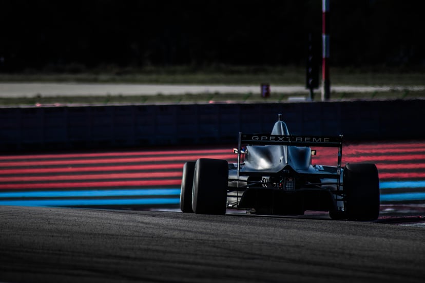 A black racing car on a track