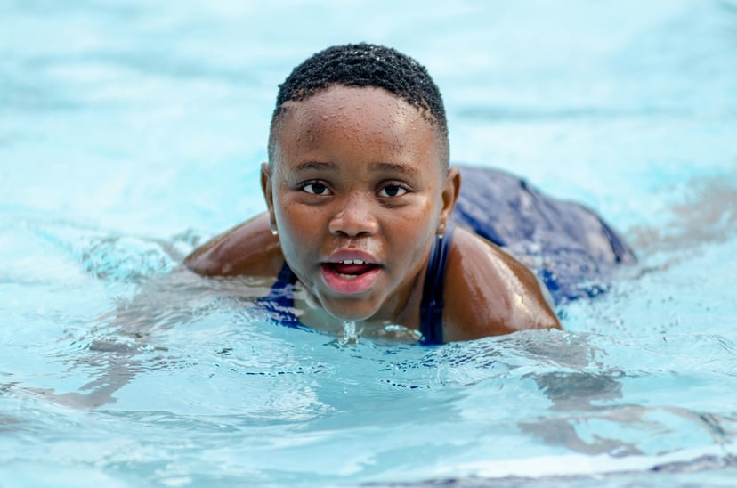 A young girl participating in a swimming lesson