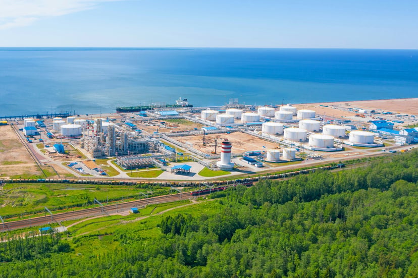 a tanker docked at a chemical plant on the coast