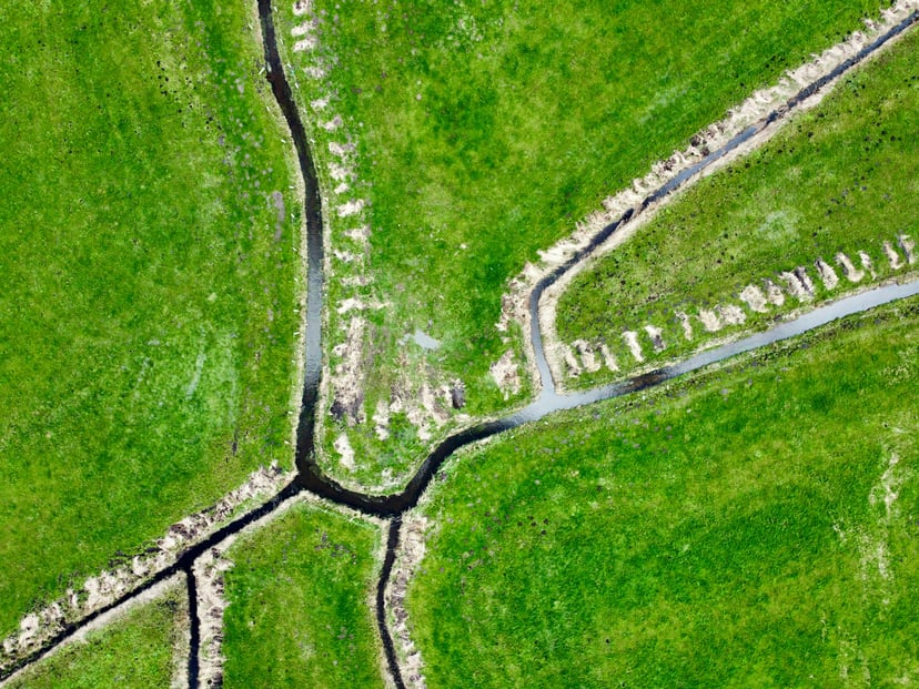 An aerial view of the Kiel Canal running through grassy fields